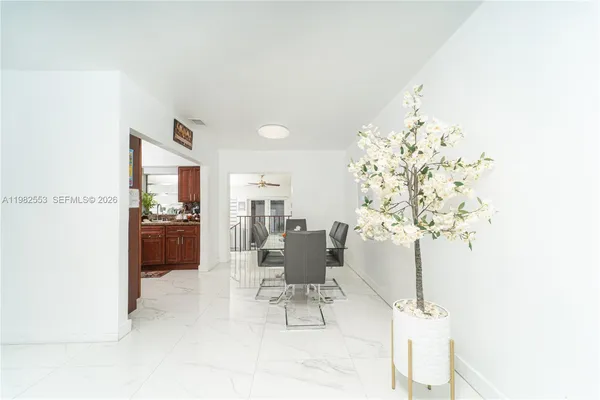 a dining room with furniture and chandelier