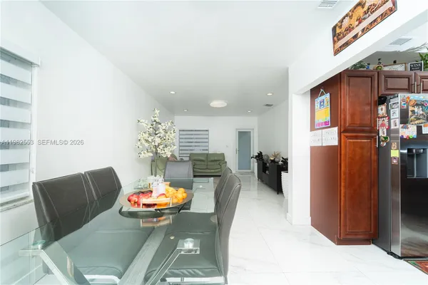 a living room with furniture flowerpot and a chandelier