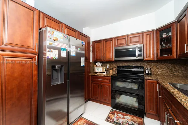 a kitchen with stainless steel appliances a stove sink and microwave