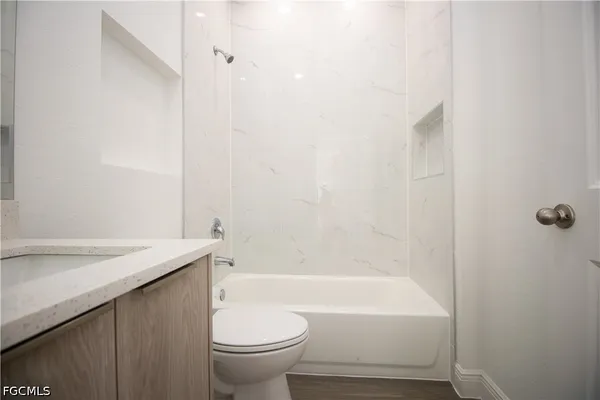a bathroom with a sink a toilet and a bathtub