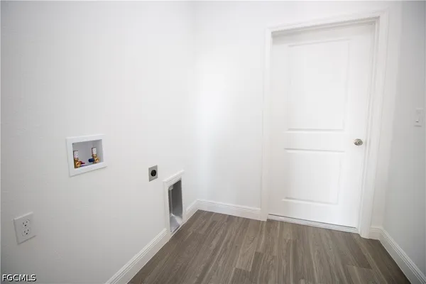 a view of a small space with wooden floor and a window