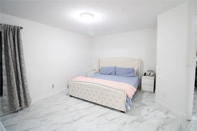 a room with a bed and a night stand