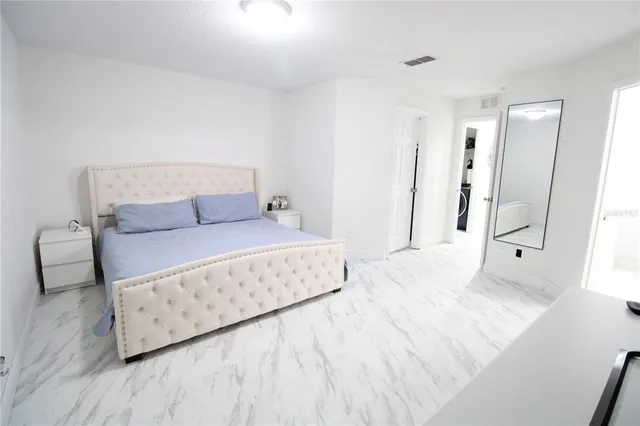 a bedroom with a bed and a night stand