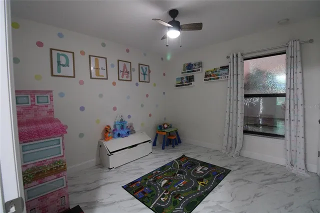 a very nice looking room with a ceiling fan