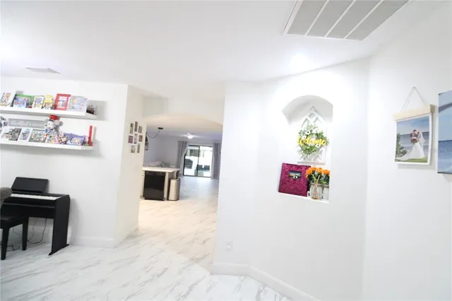 a kitchen with stainless steel appliances cabinets and a couch