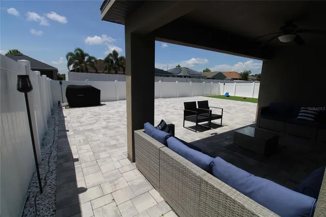 a view of yard with swimming pool and seating area