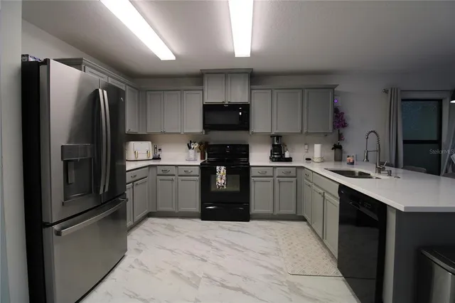a kitchen with a refrigerator sink and stove