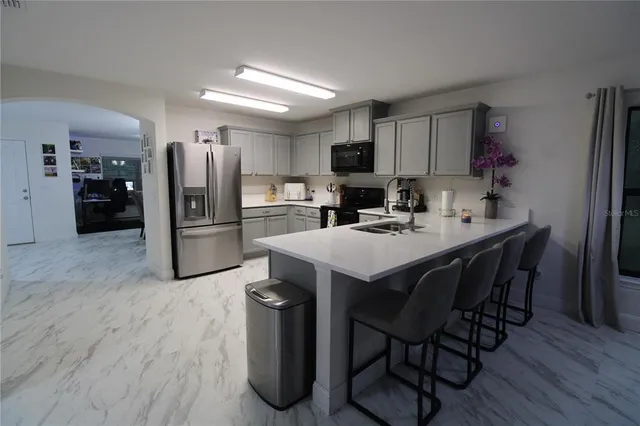 a kitchen with refrigerator and microwave