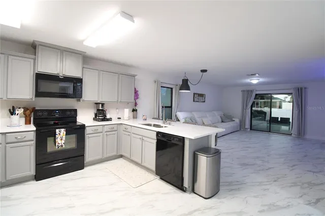 a kitchen with a sink stove and refrigerator