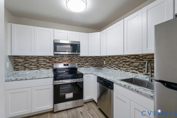 4605 Cogbill Road Richmond, VA 23234 - Photo 6 of 20 Kitchen featuring white shaker-style cabinetry, st