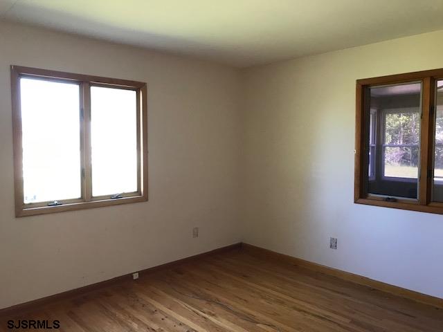 41 Roberts Road Bridgeton, NJ 08302 - Photo 14 of 15 an empty room with wooden floor and windows