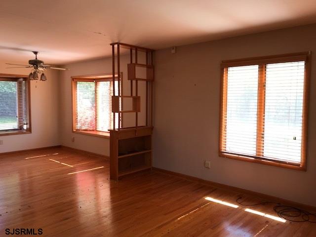 41 Roberts Road Bridgeton, NJ 08302 - Photo 6 of 15 an empty room with wooden floor and windows