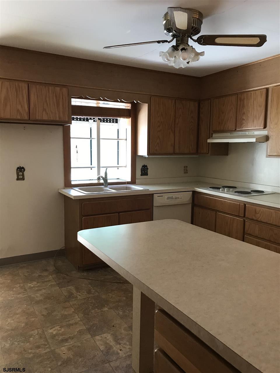 41 Roberts Road Bridgeton, NJ 08302 - Photo 10 of 15 a kitchen with stainless steel appliances granite countertop a sink a stove and a microwave oven