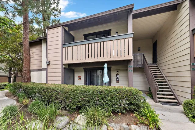 a front view of a house with garage and garden
