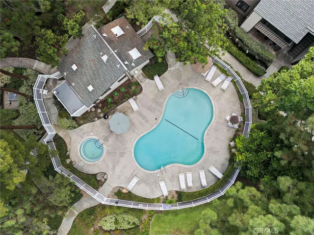 an aerial view of a house with garden space and street view
