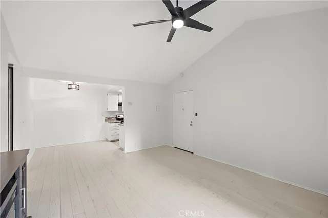 a view of a room with a empty space and wooden floors
