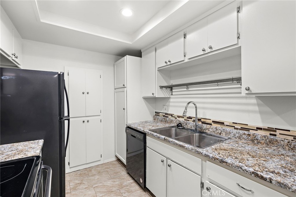 20702 El Toro, Unit 2 Lake Forest, CA 92630 - Photo 6 of 21 a kitchen with stainless steel appliances granite countertop a sink stove and refrigerator