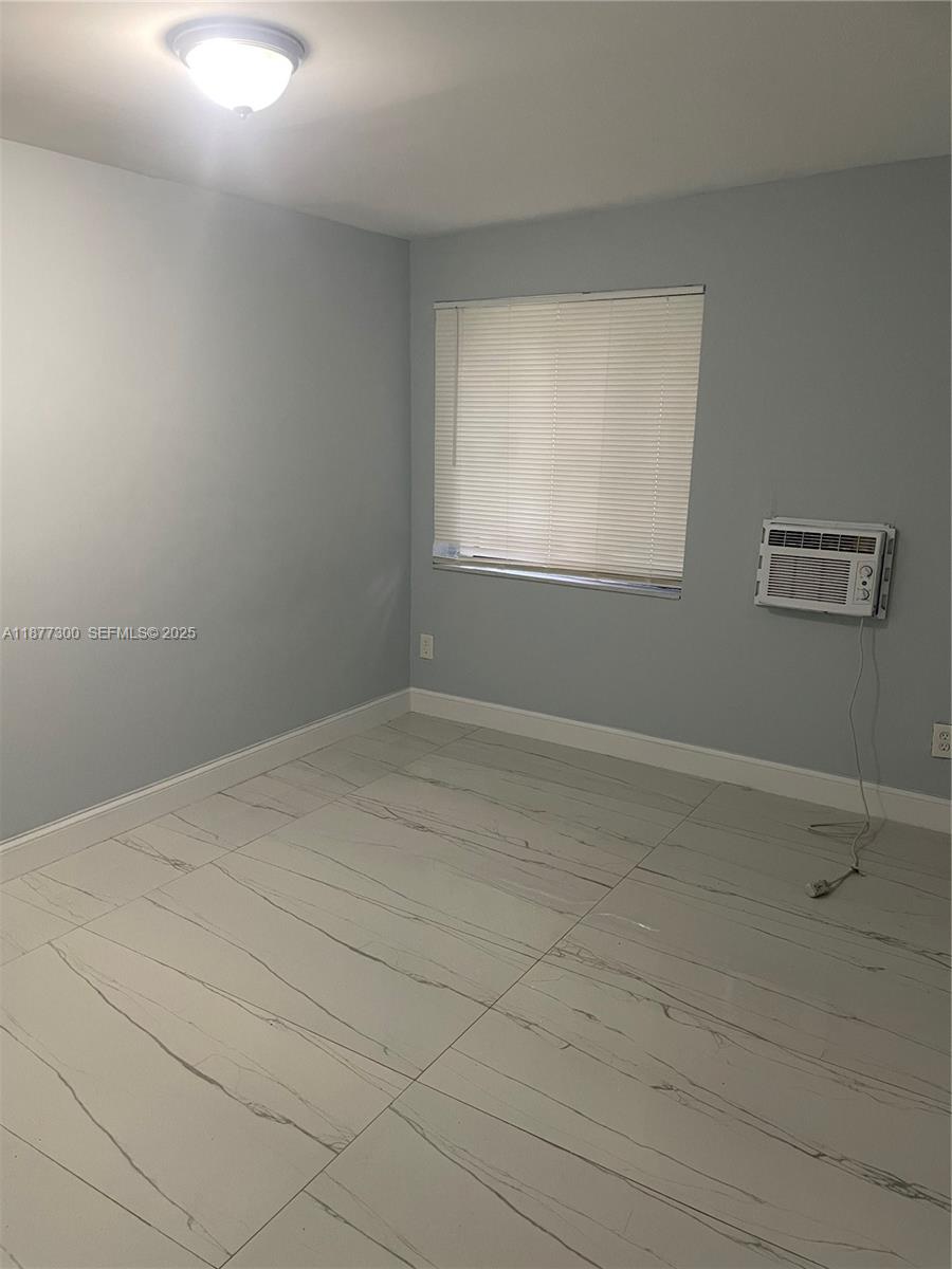 2785 Northwest 59th Street, Unit 2 Miami, FL 33142 - Photo 4 of 5 a view of a room that has a window in it