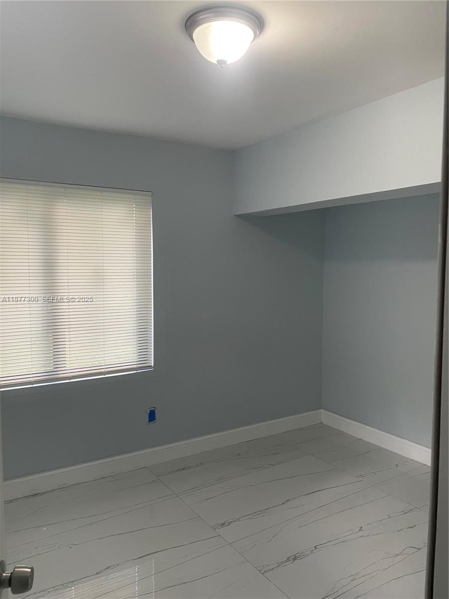 2785 Northwest 59th Street, Unit 2 Miami, FL 33142 - Photo 5 of 5 an empty room with a window