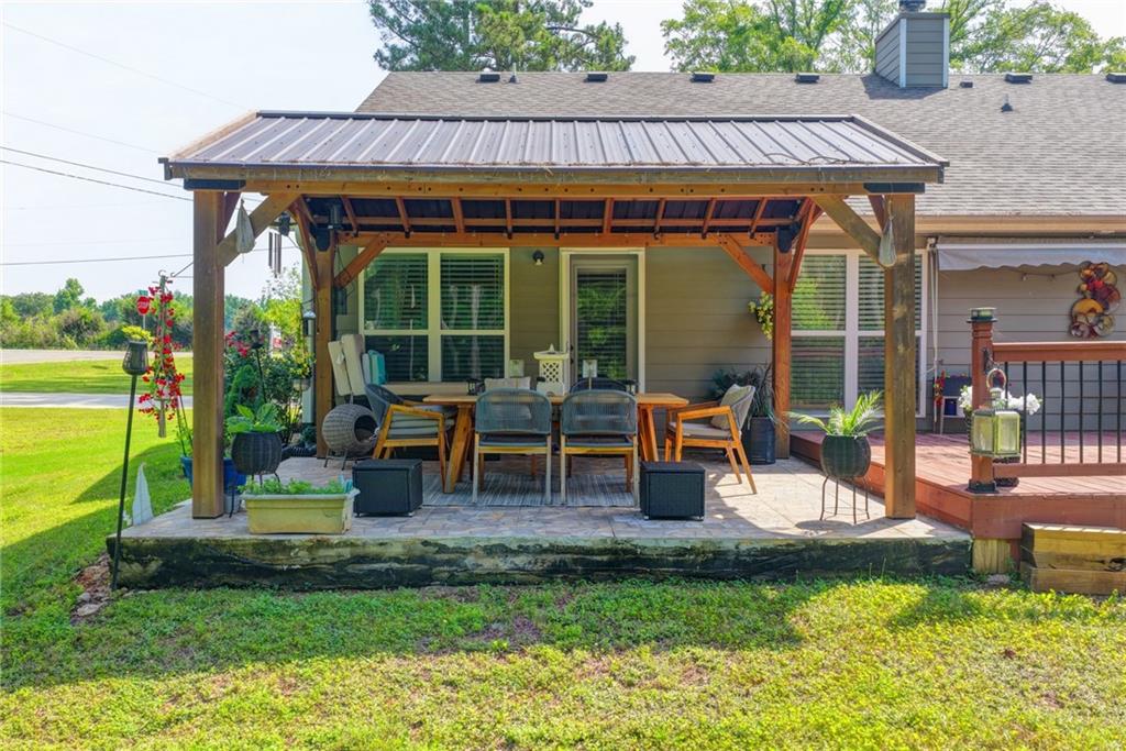 204 Lynn Road Bethlehem, GA 30620 - Photo 33 of 44 a view of a house with backyard sitting area and garden