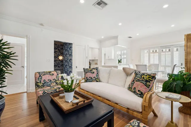 a living room with furniture a flat screen tv and kitchen view