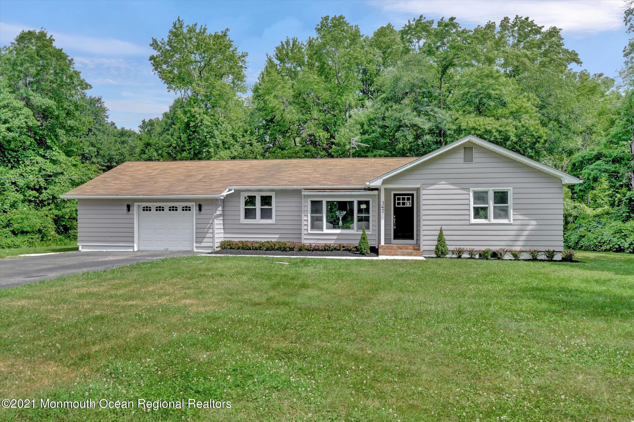 347 Iron Ore Road Manalapan, NJ 07726 - Photo 2 of 27 a front view of a house with a garden