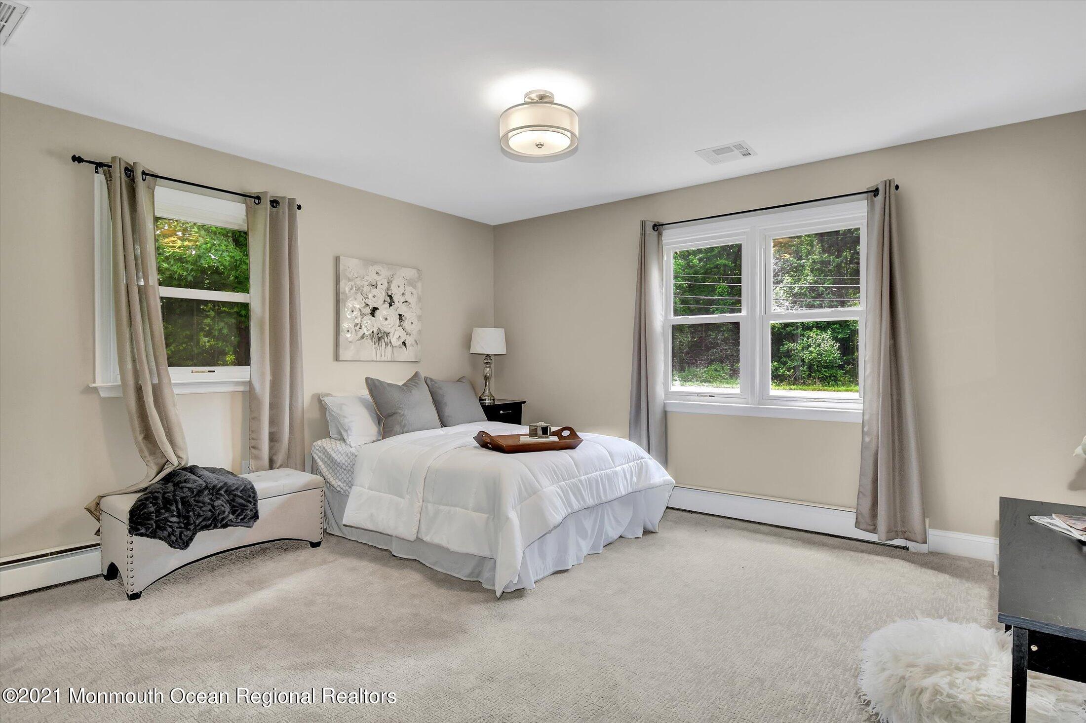 347 Iron Ore Road Manalapan, NJ 07726 - Photo 16 of 27 a bedroom with a bed and a window