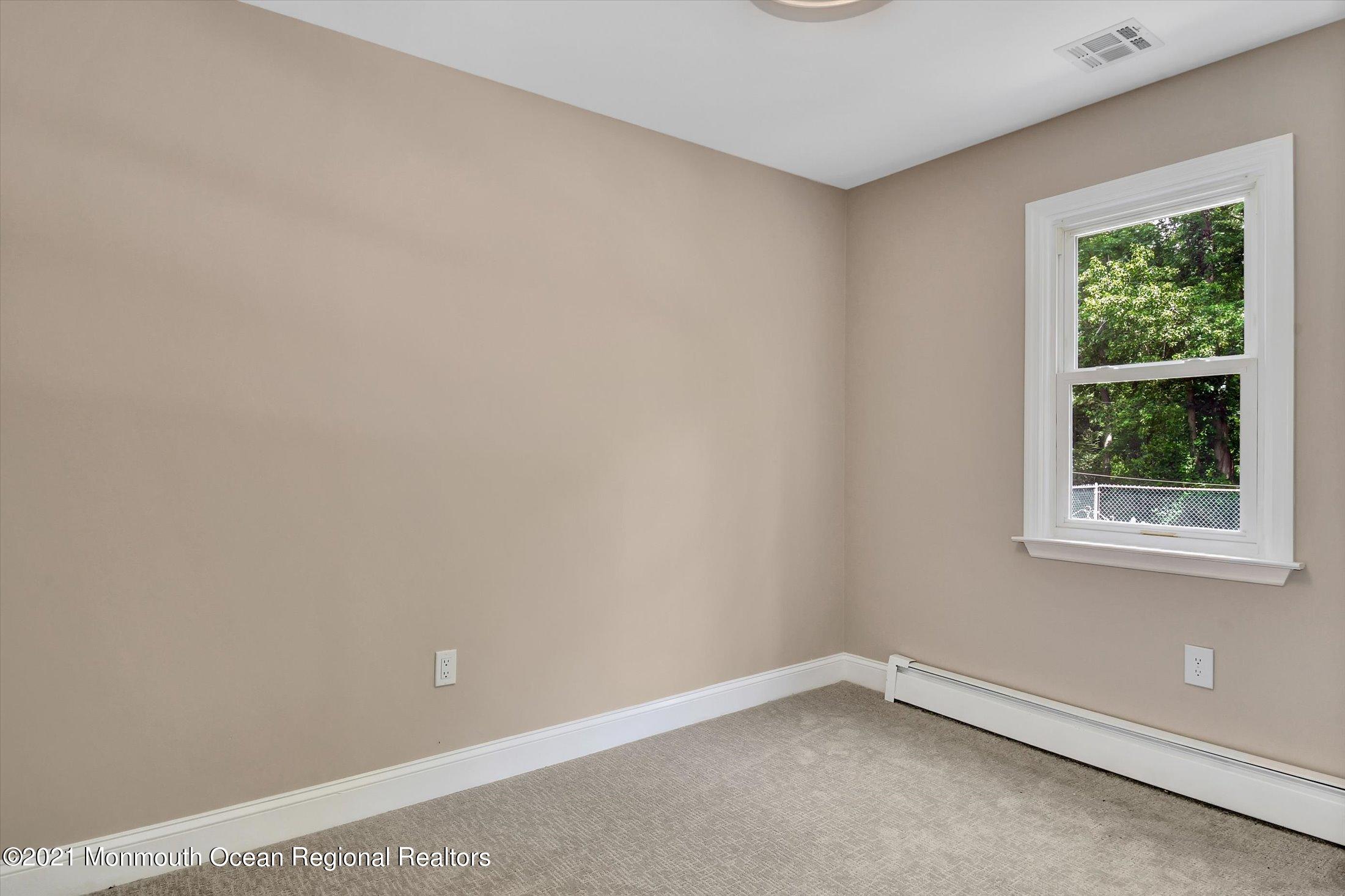347 Iron Ore Road Manalapan, NJ 07726 - Photo 18 of 27 an empty room with a window