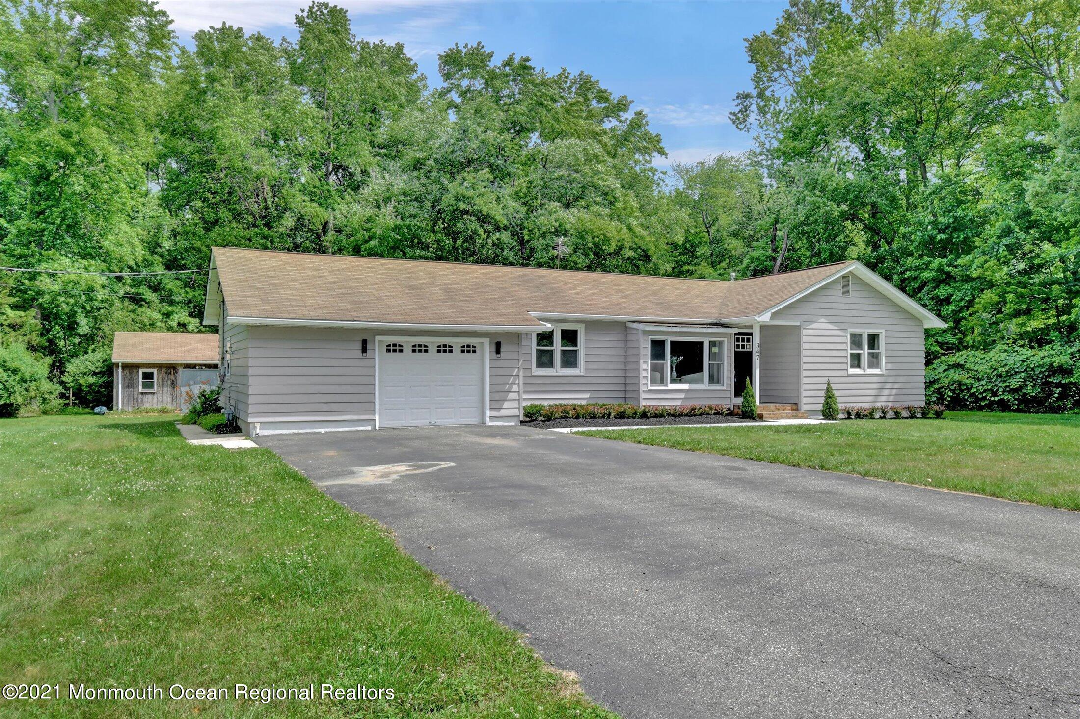 347 Iron Ore Road Manalapan, NJ 07726 - Photo 3 of 27 a view of a house with a yard and large tree