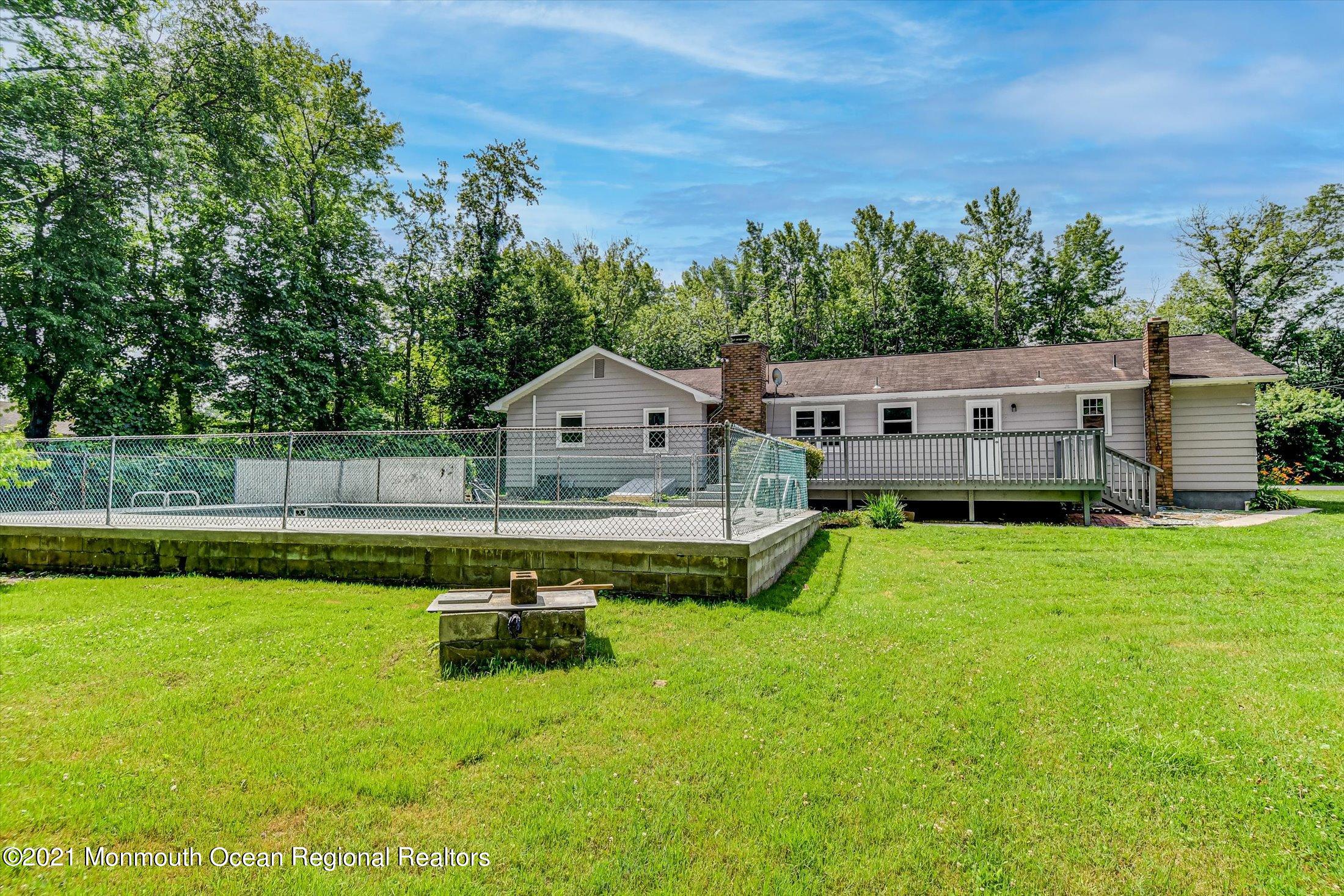 347 Iron Ore Road Manalapan, NJ 07726 - Photo 21 of 27 a view of house with garden and pool