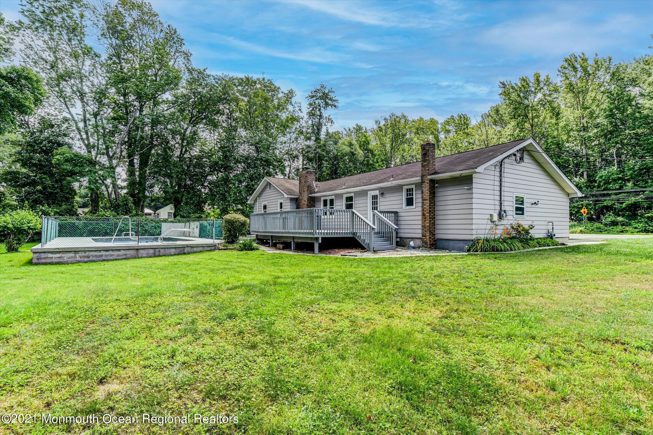 347 Iron Ore Road Manalapan, NJ 07726 - Photo 22 of 27 a view of a house with backyard and sitting area