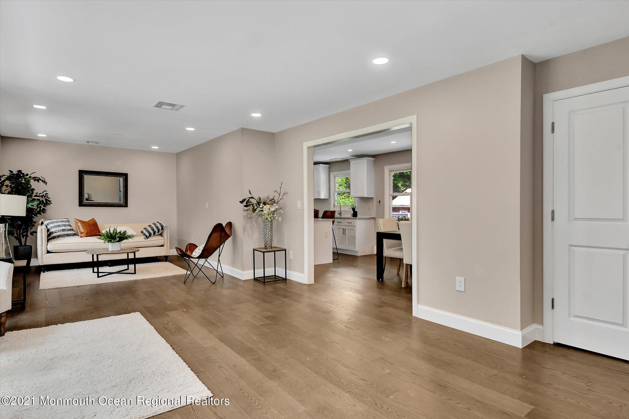 347 Iron Ore Road Manalapan, NJ 07726 - Photo 6 of 27 a living room with furniture and a wooden floor