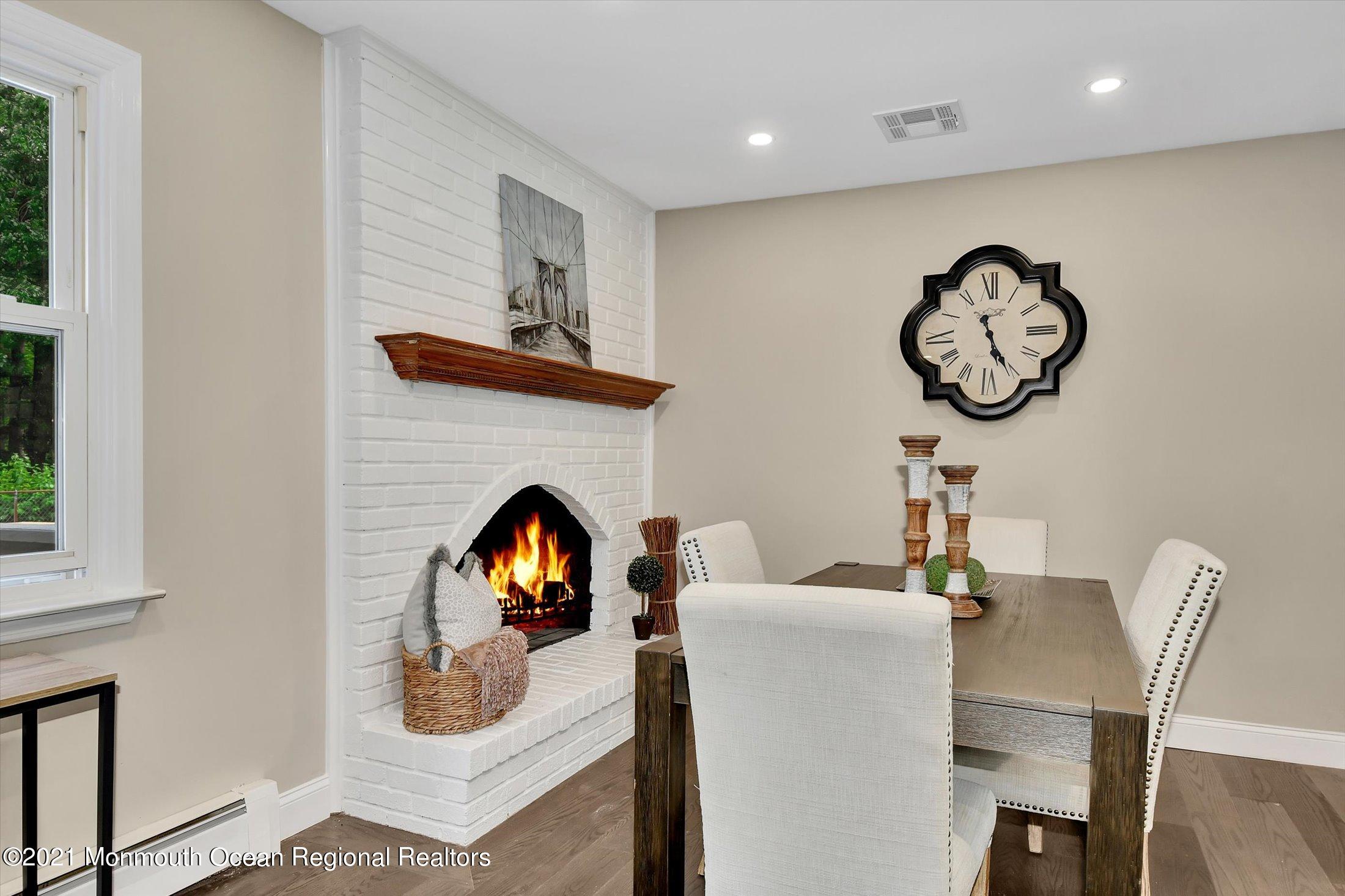 347 Iron Ore Road Manalapan, NJ 07726 - Photo 9 of 27 a living room with furniture a fireplace and window