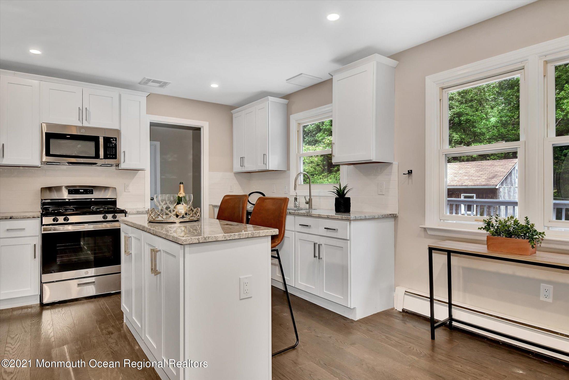347 Iron Ore Road Manalapan, NJ 07726 - Photo 10 of 27 a kitchen with a sink stove and microwave