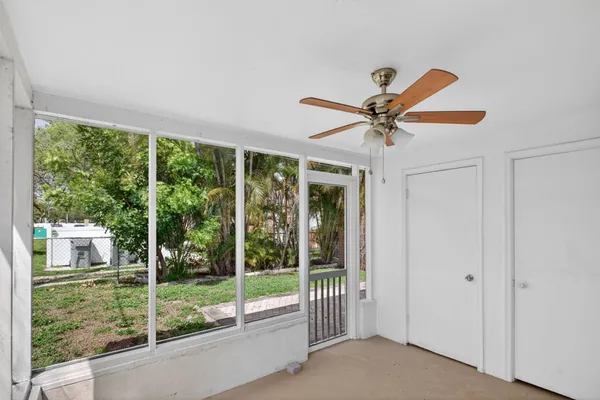 a view of a livingroom with a ceiling fan and a large window
