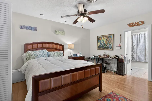 a bedroom with a bed and a chandelier