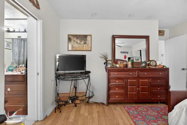 a room with a dresser and a mirror