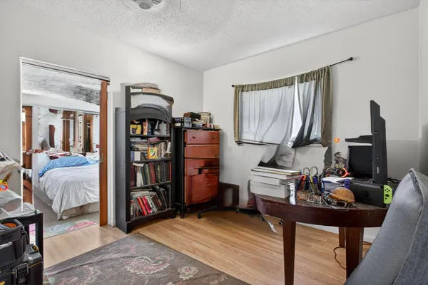 a bedroom with furniture and a book shelf