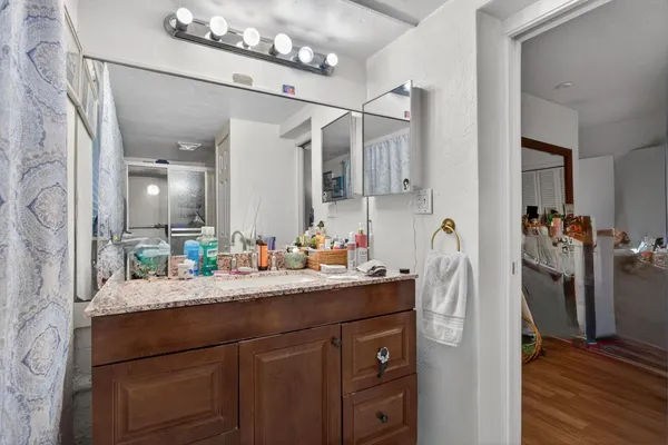 a bathroom with a sink a mirror and a shower