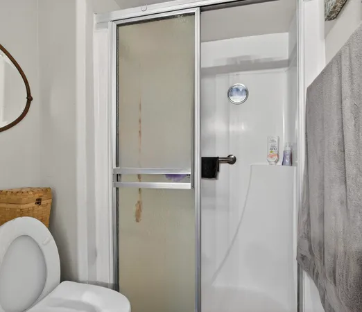 a bathroom with a granite countertop shower and a sink