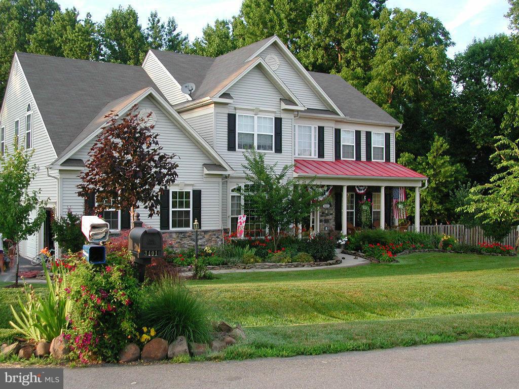 3401 Evans Road Huntingtown, MD 20639 - Photo 1 of 30 a front view of a house with a yard