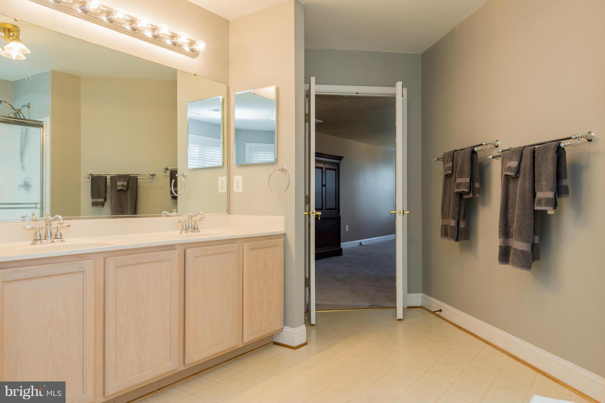 3401 Evans Road Huntingtown, MD 20639 - Photo 14 of 30 a bathroom with a double vanity sink and mirror