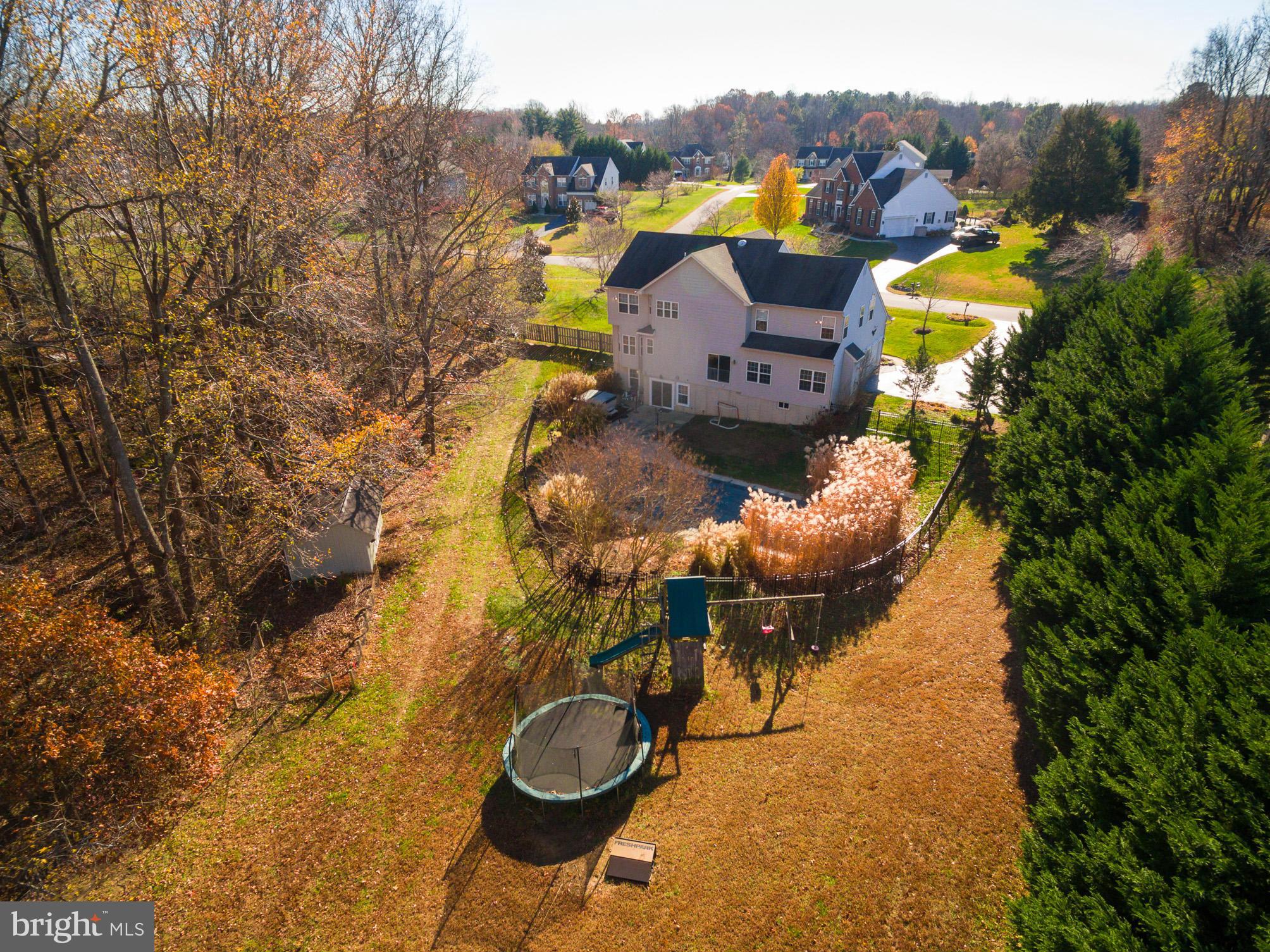 3401 Evans Road Huntingtown, MD 20639 - Photo 25 of 30 a view of a house with a swimming pool and a yard