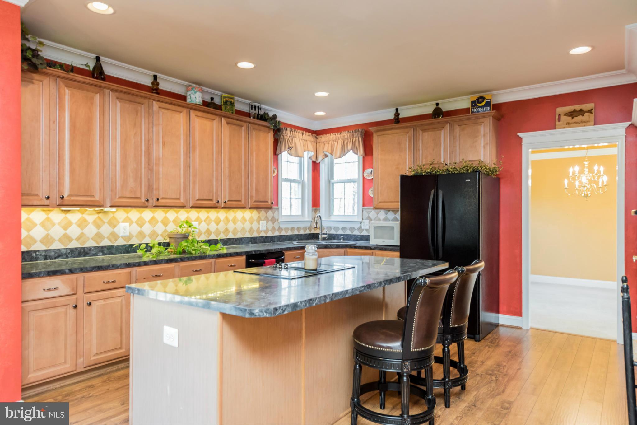 3401 Evans Road Huntingtown, MD 20639 - Photo 5 of 30 a kitchen with stainless steel appliances granite countertop a refrigerator a sink a stove and island