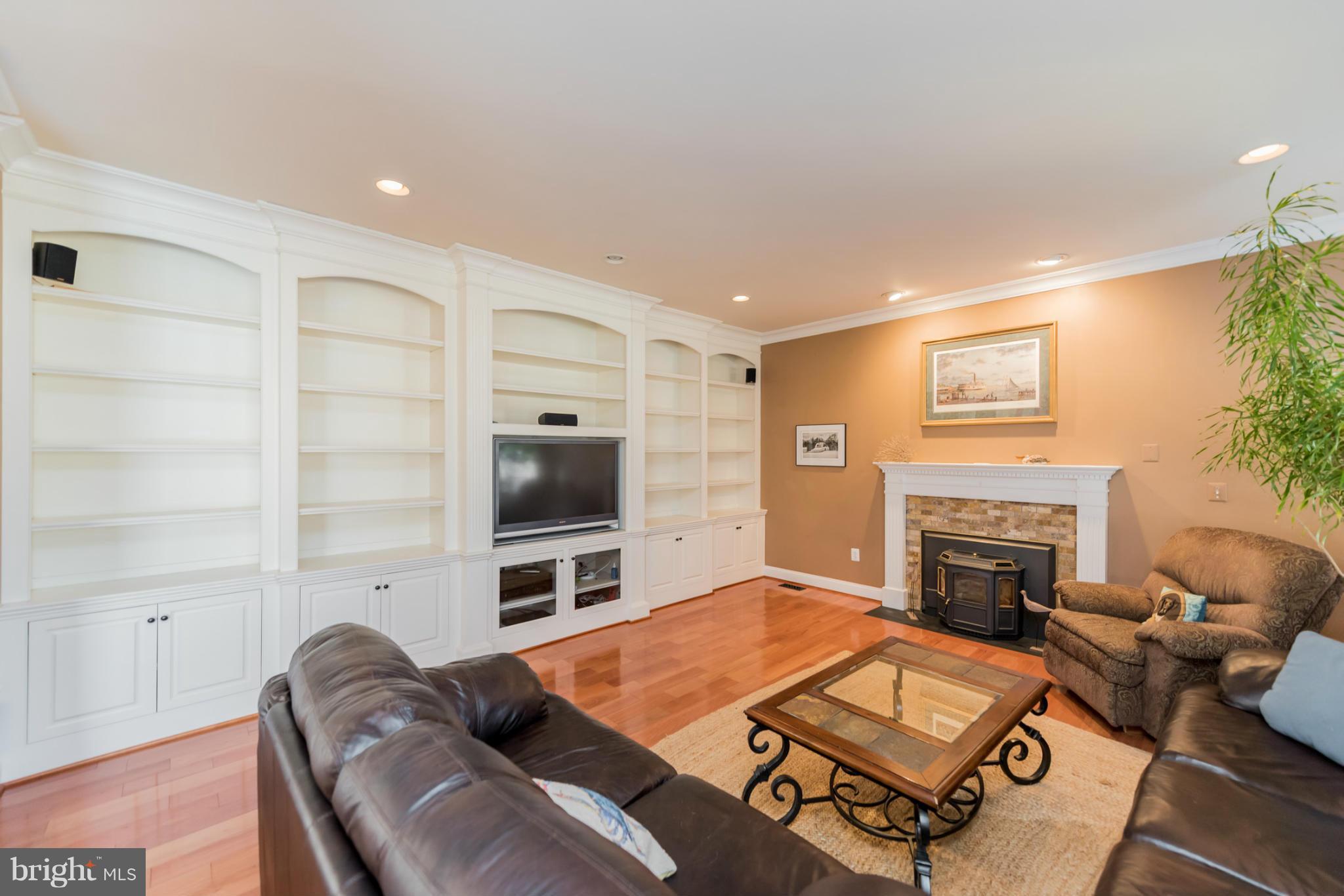 3401 Evans Road Huntingtown, MD 20639 - Photo 6 of 30 a living room with furniture a flat screen tv and a fireplace