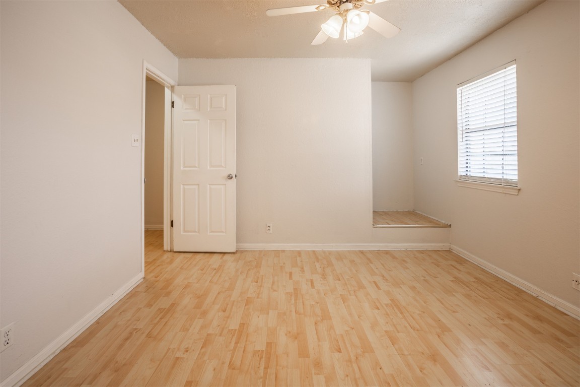 7800 Northcrest Boulevard, Unit 203 Austin, TX 78752 - Photo 15 of 19 an empty room with wooden floor and windows