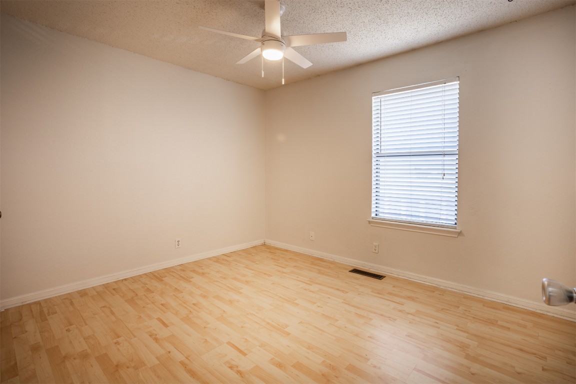 7800 Northcrest Boulevard, Unit 203 Austin, TX 78752 - Photo 16 of 19 wooden floor in an empty room with a window