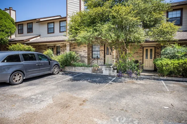a view of a car parked in front of a house