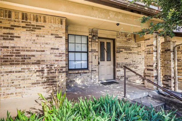 a view of front door of house with stairs