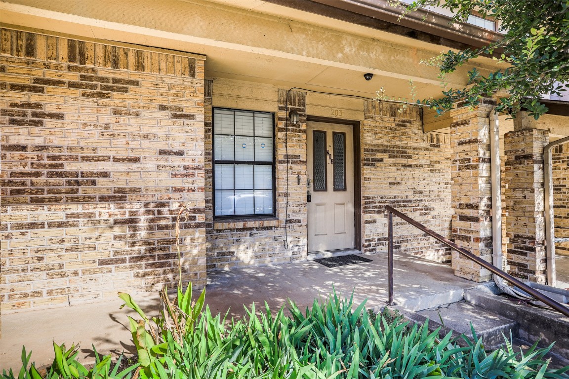 7800 Northcrest Boulevard, Unit 203 Austin, TX 78752 - Photo 3 of 19 a view of front door of house with stairs